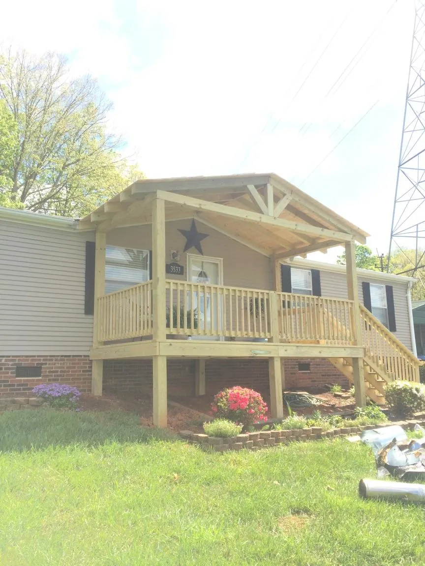 New gabled porch roof and deck railing added to a ranch home in Highland